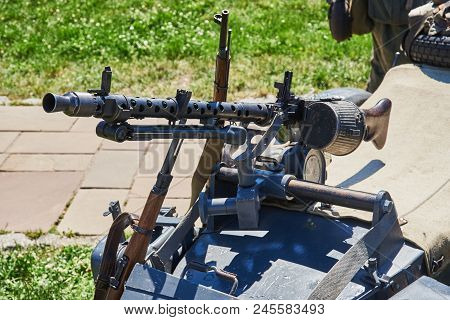 The Machine Gun Is Fixed On The Buggy Of The Motorcycle. Rifles Are Leaning Against The Buggy Of A M