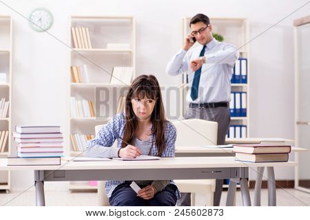 Male lecturer giving lecture to female student