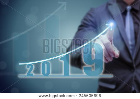 Business Man Point Hand On The Top Of Arrow Graph With High Rate Of Growth. The Success And Growing 