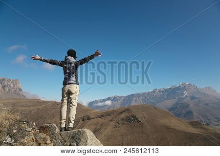 An Applause Of A Young Woman Backpacker On Top Of A Sprawling Upward Mountain Peak. Freedom And Vict