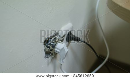 The Wire Is Thrusted Into A Broken Electrical Socket, White European 220v Electric Outlet, Cee 7 7 P