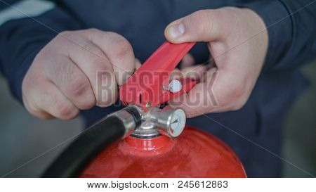 Instructor Teaches The Use Of A Fire Extinguisher, Discharge Locking Pin And Seal, Class A And B, Fi
