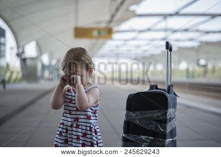 Little Sweet Girl With A Large Travel Suitcase On A Deserted Railway Perone Cries And A Third Eye