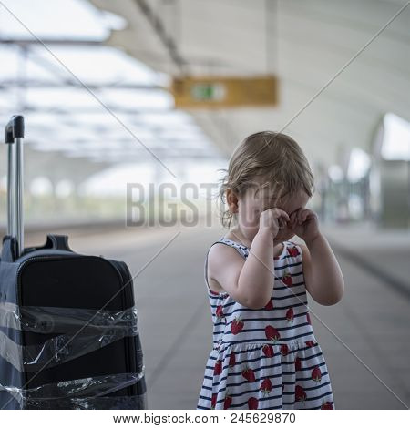 Little Sweet Girl With A Large Travel Suitcase On A Deserted Railway Perone Cries And A Third Eye
