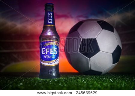 Baku,azerbaijan - June 15, 2018 : Bottle Of Efes Pilsner Beer On Grass With Soccer Ball And Blurred