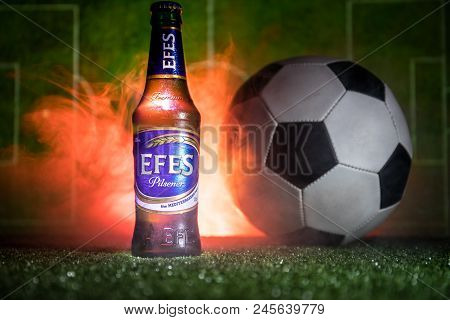 Baku,azerbaijan - June 15, 2018 : Bottle Of Efes Pilsner Beer On Grass With Soccer Ball And Blurred
