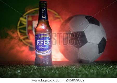 Baku,azerbaijan - June 15, 2018 : Bottle Of Efes Pilsner Beer On Grass With Soccer Ball And Blurred