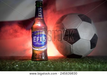Baku,azerbaijan - June 15, 2018 : Bottle Of Efes Pilsner Beer On Grass With Soccer Ball And Blurred