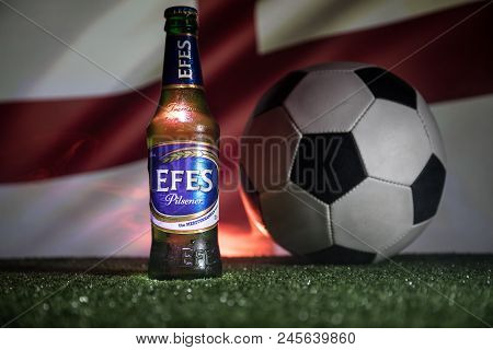 Baku,azerbaijan - June 15, 2018 : Bottle Of Efes Pilsner Beer On Grass With Soccer Ball And Blurred