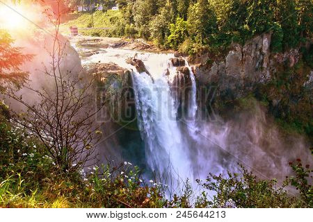 Morning Sun Peeks Through The Trees At Snoqualmie Falls In Washington State Near Seattle. The Waterf