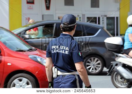 San Remo, Italy - June 10, 2018: Italian Policeman (polizia Locale) In Uniform Controlling Road Traf