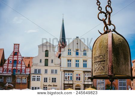 Weight Of Old Crane Hanging In Front Of Facade Of Historical Buildings In Harbor Lueneburg, Lower Sa