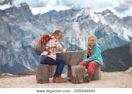 Two Tourist Girls At The Dolomites