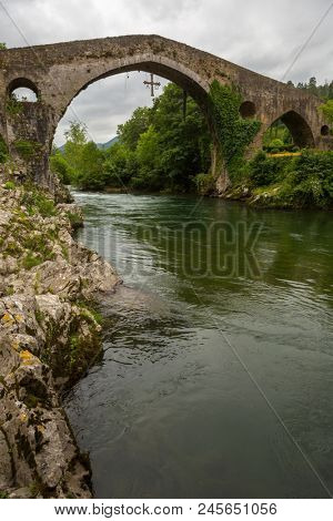 the Roman bridge built in the late 13th century over the Sella River in Cangas de Onis, Asturias, Spain.