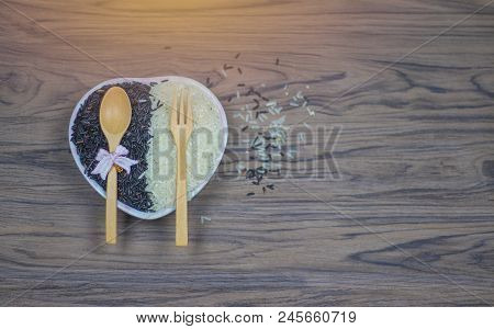 On Seletive Focus Of  Heart-shaped Cup That Put Rice Berry & Spoon And Fork Paste Above.