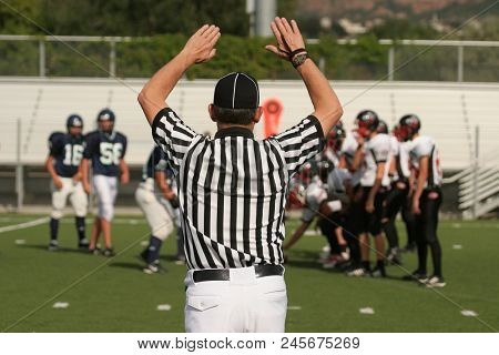Youth Football Referee Getting The Players To The Line For The Next Play