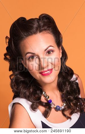 Pretty Brunette With Hairdo And Make Up Poses In Studio, Pin-up Style, Close-up Portrait
