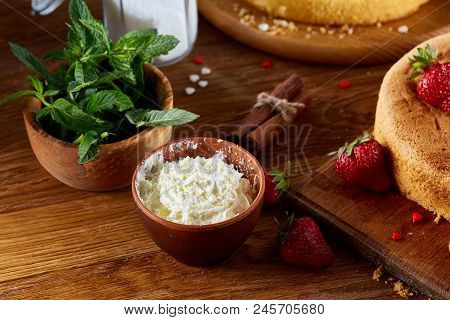 Baking Background With Strawberry Tart Covered With Whipped Sour Cream Surrounded By Organic Ingredi