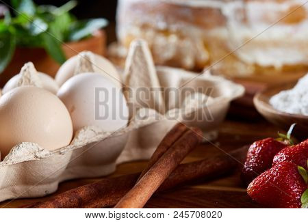 Top View Raw Ingredients For Cooking Strawberry Pie Or Cake On Wooden Table: Eggs, Sugar, Mint And S