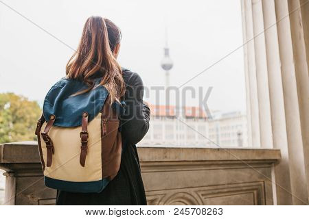 A Young Girl Traveler Or Tourist Or Student With A Backpack Travels To Berdlin In Germany.