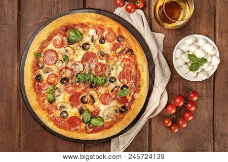 An Overhead Photo Of Pepperoni Pizza With A Glass Of White Wine, Cherry Tomatoes And Mozzarellini Ch