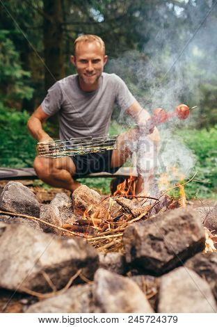 Man Near Campfire Prepare Vegetabels For Grill