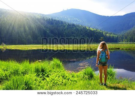 Tourist by moraine lake Kleiner Arbersee in National park Bavarian forest. Germany.