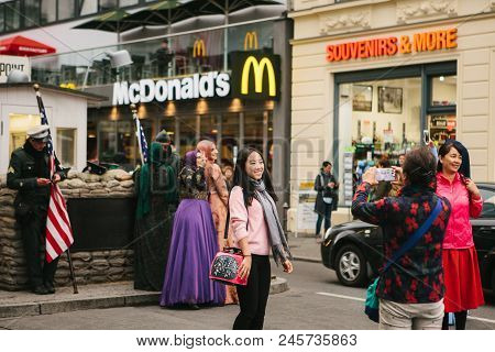 Berlin, October 1, 2017: Asian Tourists Are Photographed Next To A Famous City Attraction Called Che