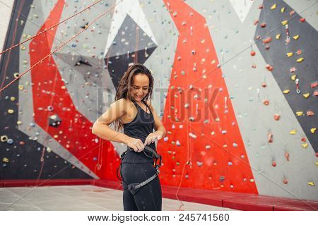 Athletic Strong Woman Preparing For Rope Climbing Exercise At The Local Gym.