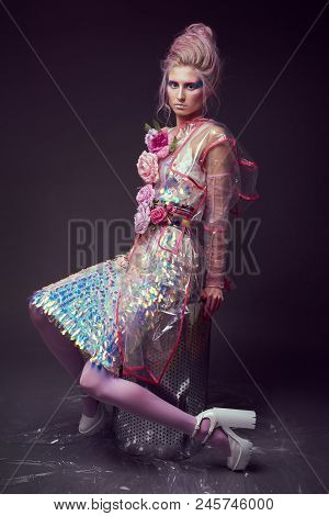 Gorgeous Woman In Biofuture Pompadour Style. Female In Fashion Transparent Raincoat With Splendid Ma