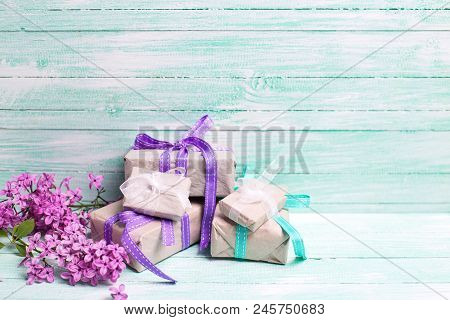 Llac Flowers  And Boxes With Gifts On Turquoise Background. Selective Focus. Place For Text.