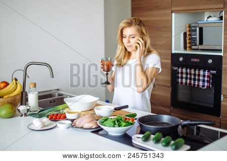 Smiling Caucasian Woman While Making Healthy Meal, Drinking Smoothie And Talking With A Friend At Ph