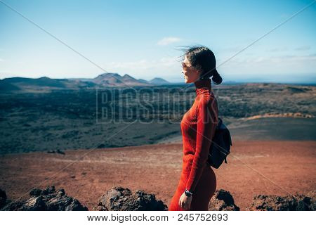 Young Woman Enjoy Unique Volcanic Landscapes Of Timanfaya National Park, Lanzarote, Canary Island. T