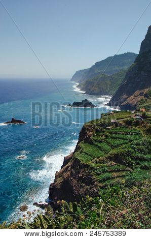 Steep Northern Coastline Of Madeira Island, Washed By Atlantic Ocean And Surrounded By High Mountain