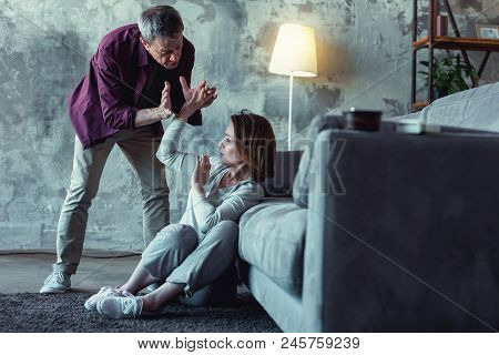 Crazy Man. Crazy Grey-haired Elderly Man Feeling Extremely Angry While Shouting At His Young Wife In