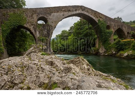 the Roman bridge built in the late 13th century over the Sella River in Cangas de Onis, Asturias, Spain.