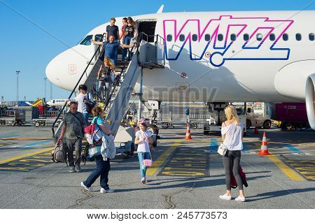 Copenhagen, Denmark - Jun 13, 2018: People Leave An Airplane At An Airport. Copenhagenis The Capital