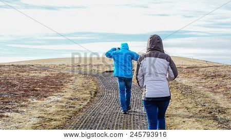 Tourists Walk To Fjord, Iceland Pennisula Bay