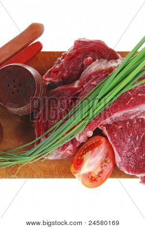 meat portion: bloody beef fillet on plate with cutlery served before cooking