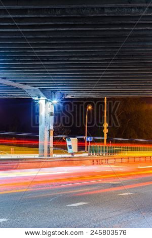 Stationary Car Speed Radar Near A Highway Road. Night Road Traffic Background