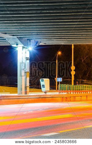 Stationary Car Speed Radar Near A Highway Road. Night Road Traffic Background