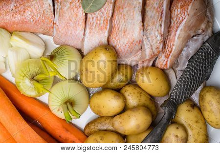 Fish Raw Snapper With Herb Spices For Fish In Glass Jar, Pepper, Bay Leaf, Celery On Dark Wood Backg