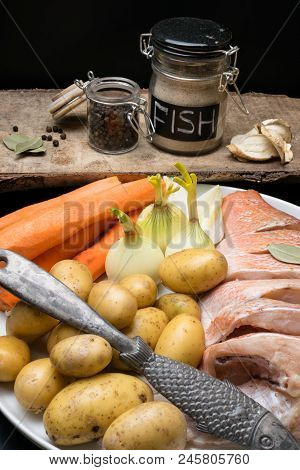Fish Raw Snapper With Herb Spices For Fish In Glass Jar, Pepper, Bay Leaf, Celery On Dark Wood Backg