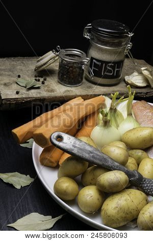 Fish Raw Snapper With Herb Spices For Fish In Glass Jar, Pepper, Bay Leaf, Celery On Dark Wood Backg