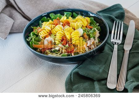 Salad made from radiatori cooked pasta, goat cheese and oil vinaigrette