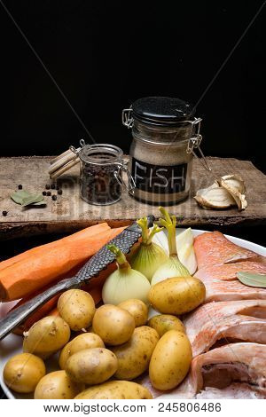 Fish Raw Snapper With Herb Spices For Fish In Glass Jar, Pepper, Bay Leaf, Celery On Dark Wood Backg