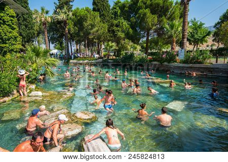Pammukale, Turkey- July, 2015: Tourists swim in antique Cleopatra pool. Color of water is caused by the presence of a large amount of radon.