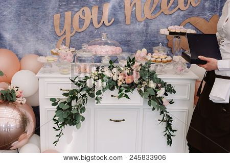 Beautiful Sweets On A Dresser. Stylish Candy Bar At A Modern Wedding. Candies, Pastries, Cakes Stand