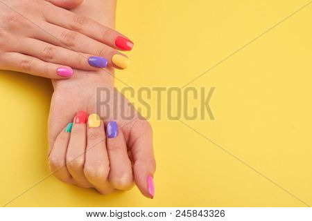 Female Pastel Manicure, Yellow Background. Woman Hands With Beautiful Colorful Summer Nails, Copy Sp