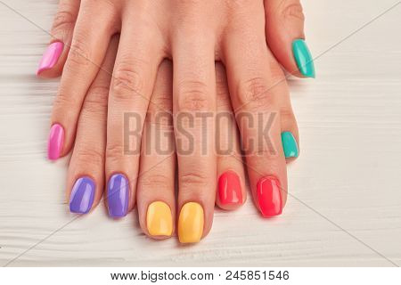 Young Woman Hands With Colorful Nails. Colorful Nail Polish On Well-groomed Woman Hands Close Up. Na